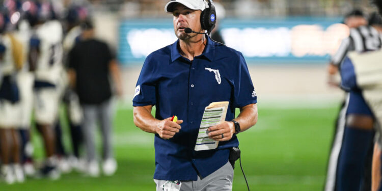 EAST LANSING, MI - AUGUST 30: Florida Atlantic Owls head coach Tom Herman talks to his coaches in the booth during a college football game between the Michigan State Spartans and the Florida Atlantic Owls on August 30, 2024, at Spartan Stadium in East Lansing, MI. (Photo by Adam Ruff/Icon Sportswire via Getty Images)