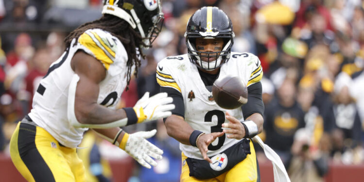 Nov 10, 2024; Landover, Maryland, USA; Pittsburgh Steelers quarterback Russell Wilson (3) tosses the ball to Steelers running back Najee Harris (22) during the second half against the Washington Commanders at Northwest Stadium. Mandatory Credit: Amber Searls-Imagn Images