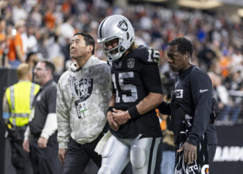 LAS VEGAS, NEVADA - NOVEMBER 24: Gardner Minshew #15 of the Las Vegas Raiders reacts to an apparent injury as he’s helped off the field during an NFL Football game against the Denver Broncos at Allegiant Stadium on November 24, 2024 in Las Vegas, Nevada. (Photo by Michael Owens/Getty Images)