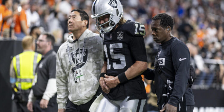 LAS VEGAS, NEVADA - NOVEMBER 24: Gardner Minshew #15 of the Las Vegas Raiders reacts to an apparent injury as he’s helped off the field during an NFL Football game against the Denver Broncos at Allegiant Stadium on November 24, 2024 in Las Vegas, Nevada. (Photo by Michael Owens/Getty Images)