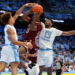 CHAPEL HILL, NORTH CAROLINA - NOVEMBER 04:  TK Simpkins #3 of the Elon Phoenix drives to the basket between Seth Trimble #7 and Jalen Washington #13 of the North Carolina Tar Heels during the first half of the game at the Dean E. Smith Center on November 04, 2024 in Chapel Hill, North Carolina.  (Photo by Grant Halverson/Getty Images)