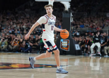 GLENDALE, ARIZONA - APRIL 08:  Cam Spencer #12 of the Connecticut Huskies dribbles the ball during the National College Basketball Championship game against the Purdue Boilermakers at State Farm Stadium on April 08, 2024 in Glendale, Arizona.  (Photo by Mitchell Layton/Getty Images)