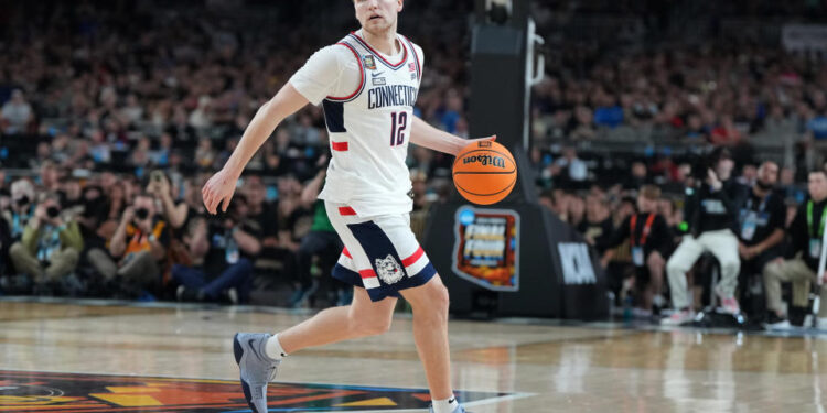 GLENDALE, ARIZONA - APRIL 08:  Cam Spencer #12 of the Connecticut Huskies dribbles the ball during the National College Basketball Championship game against the Purdue Boilermakers at State Farm Stadium on April 08, 2024 in Glendale, Arizona.  (Photo by Mitchell Layton/Getty Images)