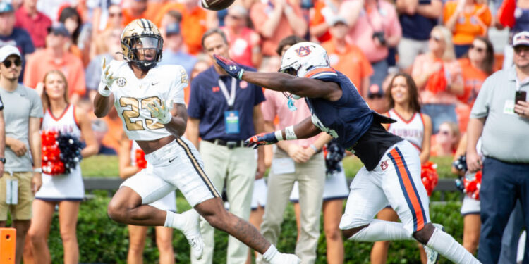 AUBURN, ALABAMA - NOVEMBER 02: Running back AJ Newberry #23 of the Vanderbilt Commodores catches a pass for a touchdown in front of linebacker Eugene Asante #9 of the Auburn Tigers during the first half of play at Jordan-Hare Stadium on November 02, 2024 in Auburn, Alabama. (Photo by Michael Chang/Getty Images)