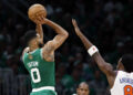 Boston, MA - October 22: Boston Celtics SF Jayson Tatum shoots a 3-point basket with pressure from New York Knicks SF OG Anunoby in the first quarter at TD Garden. (Photo by Danielle Parhizkaran/The Boston Globe via Getty Images)