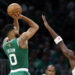 Boston, MA - October 22: Boston Celtics SF Jayson Tatum shoots a 3-point basket with pressure from New York Knicks SF OG Anunoby in the first quarter at TD Garden. (Photo by Danielle Parhizkaran/The Boston Globe via Getty Images)