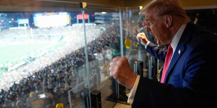 Donald Trump attends a game between the NFL Pittsburgh Steelers and the New York Jets