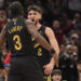 Cleveland Cavaliers guard Ty Jerome, right, celebrates a three-point basket with teammate Caris LeVert (3) in the first half of an NBA basketball game against the Golden State Warriors, Friday, Nov. 8, 2024, in Cleveland. (AP Photo/Sue Ogrocki)