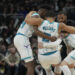 MILWAUKEE, WISCONSIN - NOVEMBER 23: Grant Williams #2 of the Charlotte Hornets helped by his teammates after being injured during the fourth quarter of a game against the Milwaukee Bucks at Fiserv Forum on November 23, 2024 in Milwaukee, Wisconsin. NOTE TO USER: User expressly acknowledges and agrees that, by downloading and or using this photograph, User is consenting to the terms and conditions of the Getty Images License Agreement. (Photo by Patrick McDermott/Getty Images)