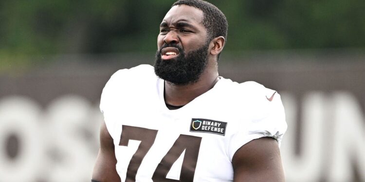 Hakeem Adeniji looks on practice field