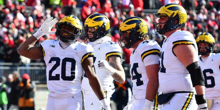 Kalel Mullings, #20 of the Michigan Wolverines, reacts after scoring a touchdown during the second quarter of a game against the Ohio State Buckeyes at Ohio Stadium on November 30, 2024, in Columbus, Ohio. (Photo by Ben Jackson/Getty Images)