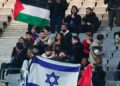 Fans hold Israel and Palestine flag