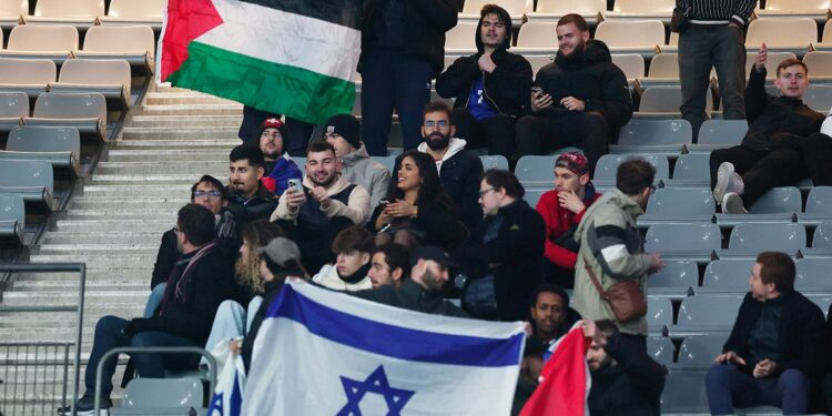 Fans hold Israel and Palestine flag