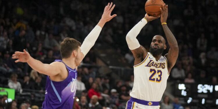 Los Angeles Lakers forward LeBron James (23) shoots the ball as Utah Jazz center Walker Kessler defends during the first half of an NBA basketball game, on Sunday, Dec. 1, 2024, in Salt Lake City. (AP Photo/Bethany Baker)