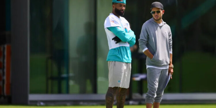 Jun 5, 2024; Miami Gardens, FL, USA; Miami Dolphins wide receiver Odell Beckham Jr. (3) and head coach Mike McDaniel look on during mandatory minicamp at Baptist Health Training Complex. Mandatory Credit: Sam Navarro-USA TODAY Sports