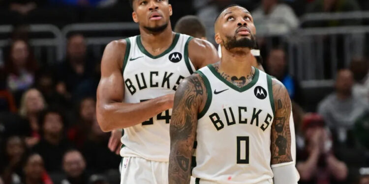 Oct 14, 2024; Milwaukee, Wisconsin, USA; Milwaukee Bucks forward Giannis Antetokounmpo (34) and guard Damian Lillard (0) look on in the second quarter against the Chicago Bulls at Fiserv Forum. Mandatory Credit: Benny Sieu-Imagn Images