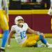 Dec 8, 2024; Kansas City, Missouri, USA; Los Angeles Chargers quarterback Justin Herbert (10) reacts after an injury during the first half against the Kansas City Chiefs at GEHA Field at Arrowhead Stadium. Mandatory Credit: Jay Biggerstaff-Imagn Images