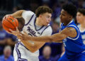 Dec 17, 2024; Kansas City, Missouri, USA; Kansas State Wildcats guard Coleman Hawkins (33) looks to pass against Drake Bulldogs guard Tavion Banks (6) during the second half at T-Mobile Center. Mandatory Credit: Jay Biggerstaff-Imagn Images