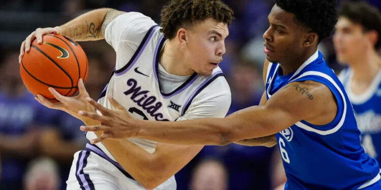 Dec 17, 2024; Kansas City, Missouri, USA; Kansas State Wildcats guard Coleman Hawkins (33) looks to pass against Drake Bulldogs guard Tavion Banks (6) during the second half at T-Mobile Center. Mandatory Credit: Jay Biggerstaff-Imagn Images