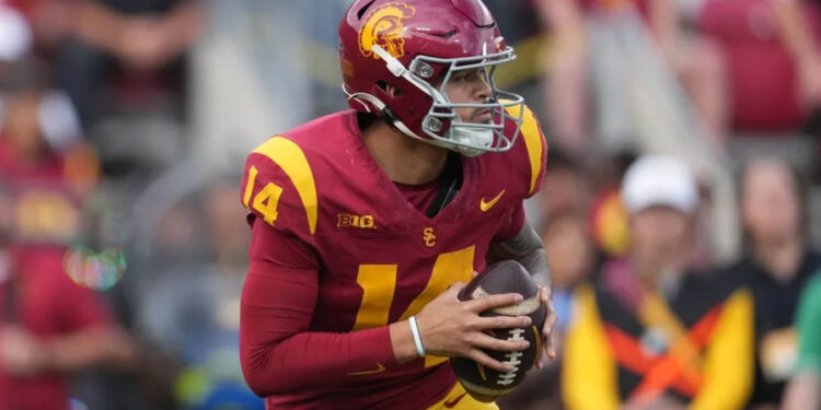 Nov 30, 2024; Los Angeles, California, USA; Southern California Trojans quarterback Jayden Maiava (14) throws the ball against the Notre Dame Fighting Irish in the first half at United Airlines Field at Los Angeles Memorial Coliseum. Mandatory Credit: Kirby Lee-Imagn Images