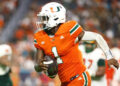 Sep 7, 2024; Miami Gardens, Florida, USA; Miami Hurricanes quarterback Cam Ward (1) runs with the football for a touchdown against the Florida A&amp;M Rattlers during the third quarter at Hard Rock Stadium. Mandatory Credit: Sam Navarro-Imagn Images