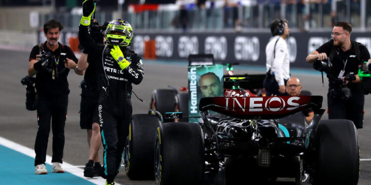 ABU DHABI, UNITED ARAB EMIRATES - DECEMBER 08: 4th placed Lewis Hamilton of Great Britain and Mercedes waves to the crowd after performing donuts on track for his final race with Mercedes during the F1 Grand Prix of Abu Dhabi at Yas Marina Circuit on December 08, 2024 in Abu Dhabi, United Arab Emirates. (Photo by Joe Portlock/Getty Images)