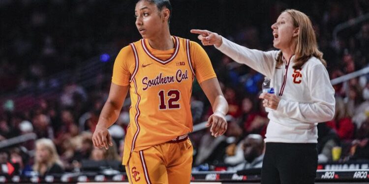 Southern California guard JuJu Watkins (12) looks back as her head coach Lindsay Gottlieb.