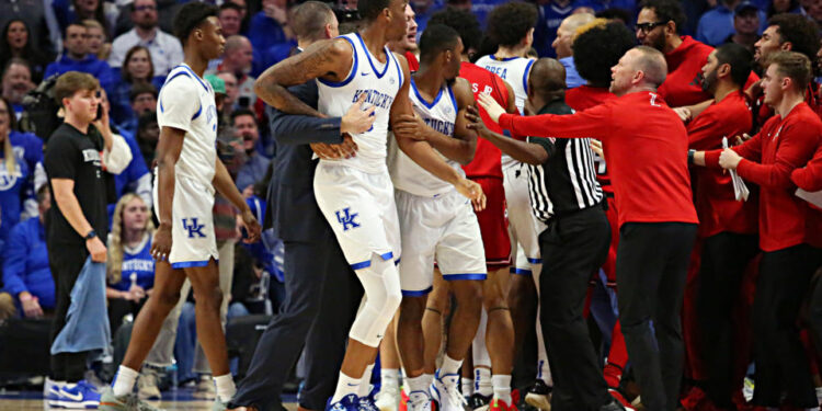 LEXINGTON, KY - DECEMBER 14: Coaches and officials attempt to break up a fight in a game between the Louisville Cardinals and the Kentucky Wildcats on December 14, 2024, at Rupp Arena in Lexington, KY. (Photo by Jeff Moreland/Icon Sportswire via Getty Images)