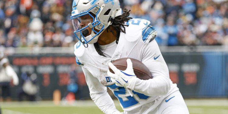 Detroit Lions running back Jahmyr Gibbs (26) runs with the ball during the first half of an NFL football game against the Chicago Bears, Sunday, Dec. 22, 2024, in Chicago. (AP Photo/Kamil Krzaczynski)