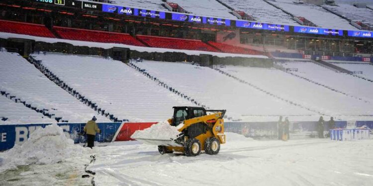 Snow is cleared from the field at Highmark Stadium in Orchard Park, N.Y., on Sunday. Gregory Fisher / Imagn Images