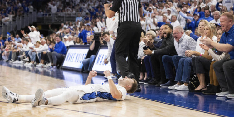 Creighton's Steven Ashworth celebrates after a foul was called on Kansas that knocked him to the floor during the first half of an NCAA college basketball game Wednesday, Dec. 4, 2024, in Omaha, Neb. (AP Photo/Rebecca S. Gratz)