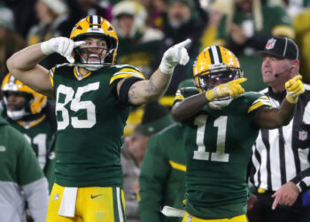 Dec 23, 2024; Green Bay, Wisconsin, USA;  Green Bay Packers wide receiver Jayden Reed (11) reacts with tight end Tucker Kraft (85) after cathing a first down pass against the New Orleans Saints at Lambeau Field. Mandatory Credit: Wm. Glasheen USA TODAY NETWORK-Wisconsin/Imagn Images