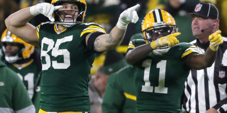 Dec 23, 2024; Green Bay, Wisconsin, USA;  Green Bay Packers wide receiver Jayden Reed (11) reacts with tight end Tucker Kraft (85) after cathing a first down pass against the New Orleans Saints at Lambeau Field. Mandatory Credit: Wm. Glasheen USA TODAY NETWORK-Wisconsin/Imagn Images