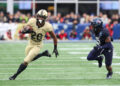 FOXBOROUGH, MA - DECEMBER 09: Army Black Knights running back Kanye Udoh (26) pursued by Navy Midshipmen defensive end Mbiti Williams Jr. (7) during the 124th Army-Navy football game on December 9, 2023, at Gillette Stadium in Foxborough, MA. (Photo by M. Anthony Nesmith/Icon Sportswire via Getty Images)