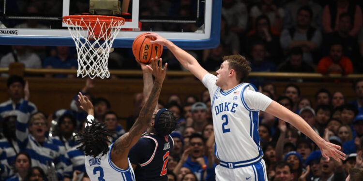 Dec 4, 2024; Durham, North Carolina, USA; Duke Blue Devils forward Cooper Flagg (2) blocks a shot by Auburn Tigers guard Denver Jones (2) during the second half at Cameron Indoor Stadium.  The Blue Devils won 84-78.   Mandatory Credit: Rob Kinnan-Imagn Images