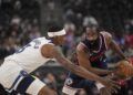 Los Angeles Clippers guard James Harden holds the ball against Minnesota Timberwolves.