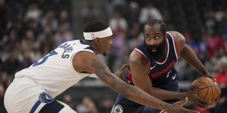 Los Angeles Clippers guard James Harden holds the ball against Minnesota Timberwolves.