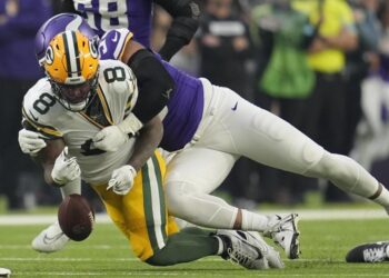 Green Bay Packers' Josh Jacobs fumbles as he is hit by Minnesota Vikings' Jerry Tillery. (AP Photo/Abbie Parr)