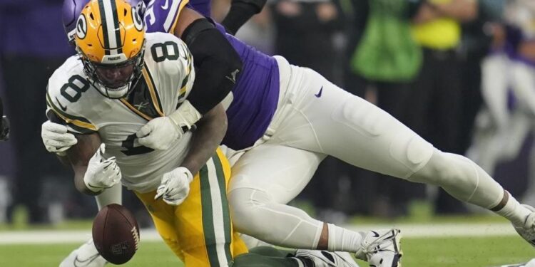 Green Bay Packers' Josh Jacobs fumbles as he is hit by Minnesota Vikings' Jerry Tillery. (AP Photo/Abbie Parr)