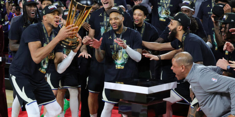 LAS VEGAS, NEVADA - DECEMBER 17: Giannis Antetokounmpo (L) #34 of the Milwaukee Bucks lifts the championship trophy as he celebrates with teammates, including Damian Lillard (C) #0, after the Bucks defeated the Oklahoma City Thunder 97-81 to win the championship game of the Emirates NBA Cup at T-Mobile Arena on December 17, 2024 in Las Vegas, Nevada. NOTE TO USER: User expressly acknowledges and agrees that, by downloading and or using this photograph, User is consenting to the terms and conditions of the Getty Images License Agreement. (Photo by Ethan Miller/Getty Images)