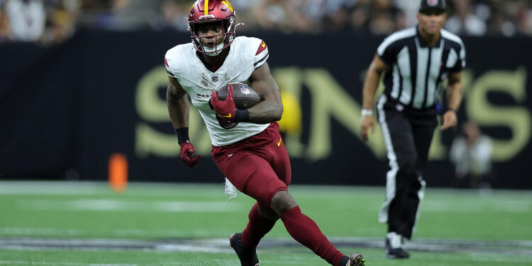 NEW ORLEANS, LOUISIANA - DECEMBER 15: Brian Robinson Jr. #8 of the Washington Commanders runs with the ball against the New Orleans Saints during a game at Caesars Superdome on December 15, 2024 in New Orleans, Louisiana. (Photo by Jonathan Bachman/Getty Images)