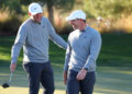 LAS VEGAS, NEVADA - DECEMBER 17: Scottie Scheffler (L) and Rory McIlroy of the PGA Tour talk during The Showdown: McIlroy and Scheffler v DeChambeau and Koepka at Shadow Creek Golf Course on December 17, 2024 in Las Vegas, Nevada.  (Photo by Kevin C. Cox/Getty Images for The Showdown)