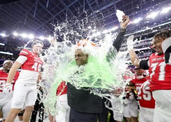 UNLV interim head coach Del Alexander is doused in a sports drink after leading the Rebels to an L.A. Bowl win over Cal