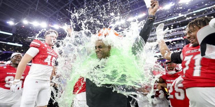 UNLV interim head coach Del Alexander is doused in a sports drink after leading the Rebels to an L.A. Bowl win over Cal