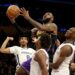 Los Angeles, CA - Lakers forward Lebron James drives to the basket against a trio of Grizzlies defenders.