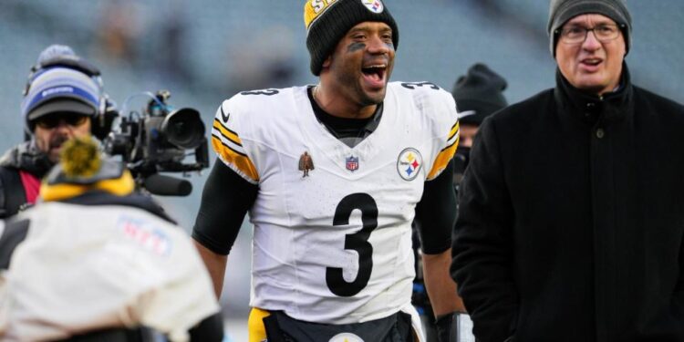 <span>Russell Wilson celebrates as he walks off the field after his team's victory over the Cincinnati Bengals.</span><span>Photograph: Jeff Dean/AP</span>