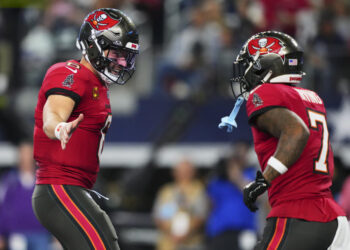 Baker Mayfield #6 of the Tampa Bay Buccaneers celebrates after scoring a touchdown against the Dallas Cowboys during an NFL football game at AT&T Stadium on December 22, 2024 in Arlington, Texas. (Photo by Cooper Neill/Getty Images)