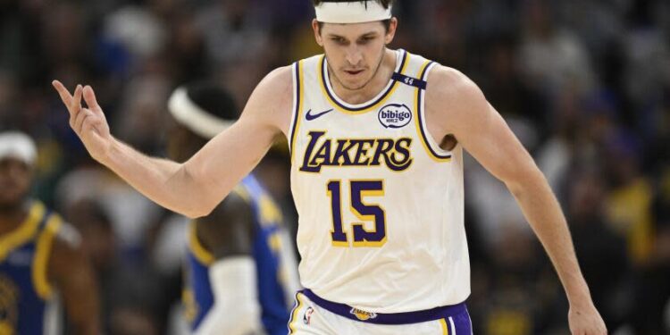 Los Angeles Lakers guard Austin Reaves (15) celebrates his three-point basket.