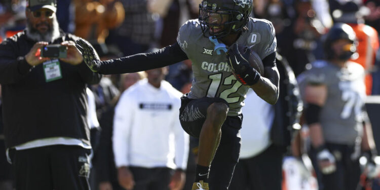 BOULDER, COLORADO - NOVEMBER 16: Travis Hunter #12 of the Colorado Buffaloes celebrates after an interception by striking the Heisman pose during the first half against the Utah Utes at Folsom Field on November 16, 2024 in Boulder, Colorado. (Photo by Aaron M. Sprecher/Getty Images)