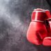 Pair of red boxing gloves hanging on the wall